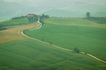 Winding road through countryside in Pienza, Tuscany, Italy.