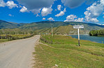 A road sign with the name of the Tungur village. Altai, Russia. Sunny summer day.