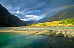 Rainbow over the river. Argut River merger with Katun. Altai Mountains, Russia. August.