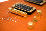 Detail of Orange Electric Guitar Body with Strings