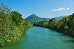 spring season on the river Toce with forest on the sides and mountains in the background and clouds in the sky