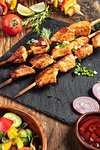 Shashlik with vegetables on an old wooden table