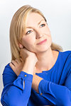 Studio portrait of attractive healthy thoughtful, middle aged woman
