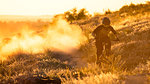 Professional Cyclist Riding the Downhill Mountain Bike on the Summer Rocky Trail at the Evening. Extreme Sport and Enduro Cycling Concept.