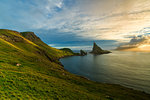 Drangarnir rock seen from the green hills along the hiking trail, Vagar island, Faroe Islands, Denmark, Europe