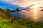 Trekker on the hiking trail to Drangarnir rock, Vagar island, Faroe Islands, Denmark, Europe