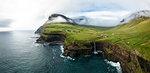 Aerial panoramic of waterfall and cliffs, Gasadalur, Vagar island, Faroe Islands, Denmark, Europe