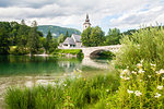 The bridge and church in the lakeside village of Ribcev Laz, Lake Bohinj, Slovenia, Europe