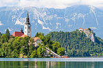 Tiny island with a church, a castle on a crag, and mountain views, Lake Bled, Slovenia, Europe