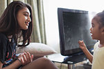 Sisters talking in living room