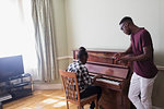 Brother and sister playing piano