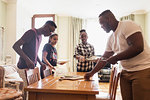 Teenage siblings setting the table