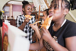 Tween girls enjoying pizza