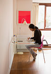 Young woman using digital tablet at desk