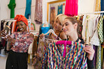 Young women friends shopping in clothing store