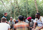 Mens group with map preparing for hike in woods