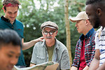 Portrait smiling man with map on hike with friends