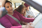 Family with map in car on road trip