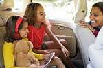 Mother and daughters riding in car