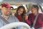 Family enjoying road trip in car