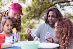 Family playing cards at campsite