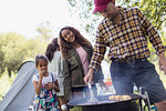 Family barbecuing at campsite