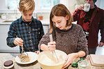 Brother and sister baking in kitchen