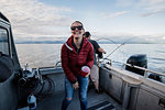 Portrait enthusiastic woman on fishing boat