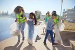 Volunteers cleaning up litter on sunny boardwalk