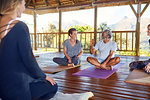 Man and woman talking during yoga class in hut on yoga retreat