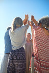 Group standing in circle with arms raised during yoga retreat