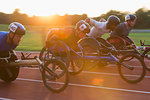 Paraplegic athletes speeding along sports track in wheelchair race