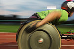 Paraplegic athlete speeding along sports track in wheelchair race