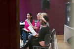 Womens choir with sheet music singing in music recording studio