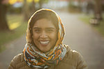 Portrait smiling, confident Muslim woman wearing hijab in park