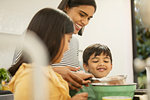 Mother and children baking in kitchen