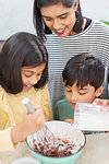 Mother and children baking