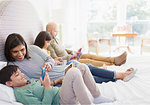 Family using technology on bed