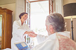 Happy, affectionate couple in bathrobes in hotel room