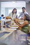 Doctors and receptionist examining medication at clinic reception