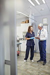 Doctor and nurse using digital tablet in clinic examination room