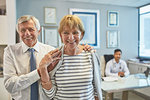 Portrait happy senior couple leaving clinic doctors office