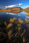 Lonscale Fell and Skiddaw reflected in the still water of Tewet Tarn, Lake District National Park, UNESCO World Heritage Site, Cumbria, England, United Kingdom, Europe