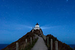 Nugget Point lighthouse under star filled sky, Kaka Point, Otago, South Island, New Zealand, Pacific