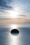 A single Moeraki Boulder at sunrise with long exposure, Moeraki Beach, Otago, South Island, New Zealand, Pacific