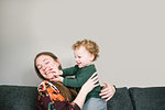 Mother and son playing on sofa