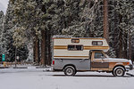 Campervan parked on snow covered ground, Yosemite National Park, California, USA