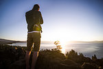 Man taking photographs at sunrise, Lake Tahoe, Tahoe City, California, United States