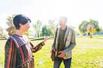 Couple teasing each other in park, Strandbad, Mannheim, Germany