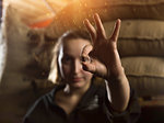 Woman holding coffee bean with two fingers